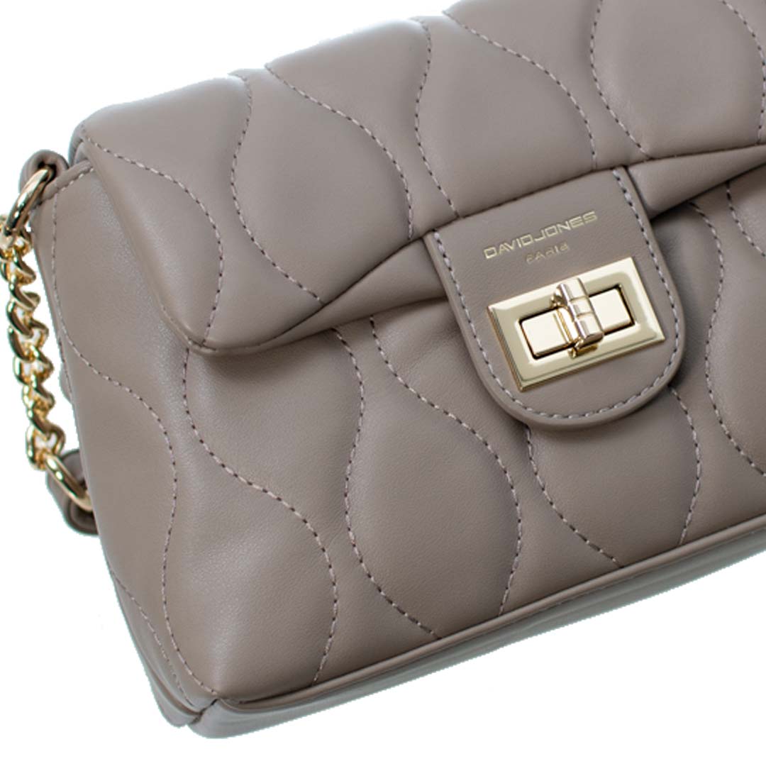 Stylish Quilted Handbag by David Jones Close-up of a taupe quilted handbag featuring a gold clasp and chain strap, showcasing elegant design details.