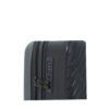 Close-up of a gray hardshell suitcase featuring a combination lock and textured surface for added protection.