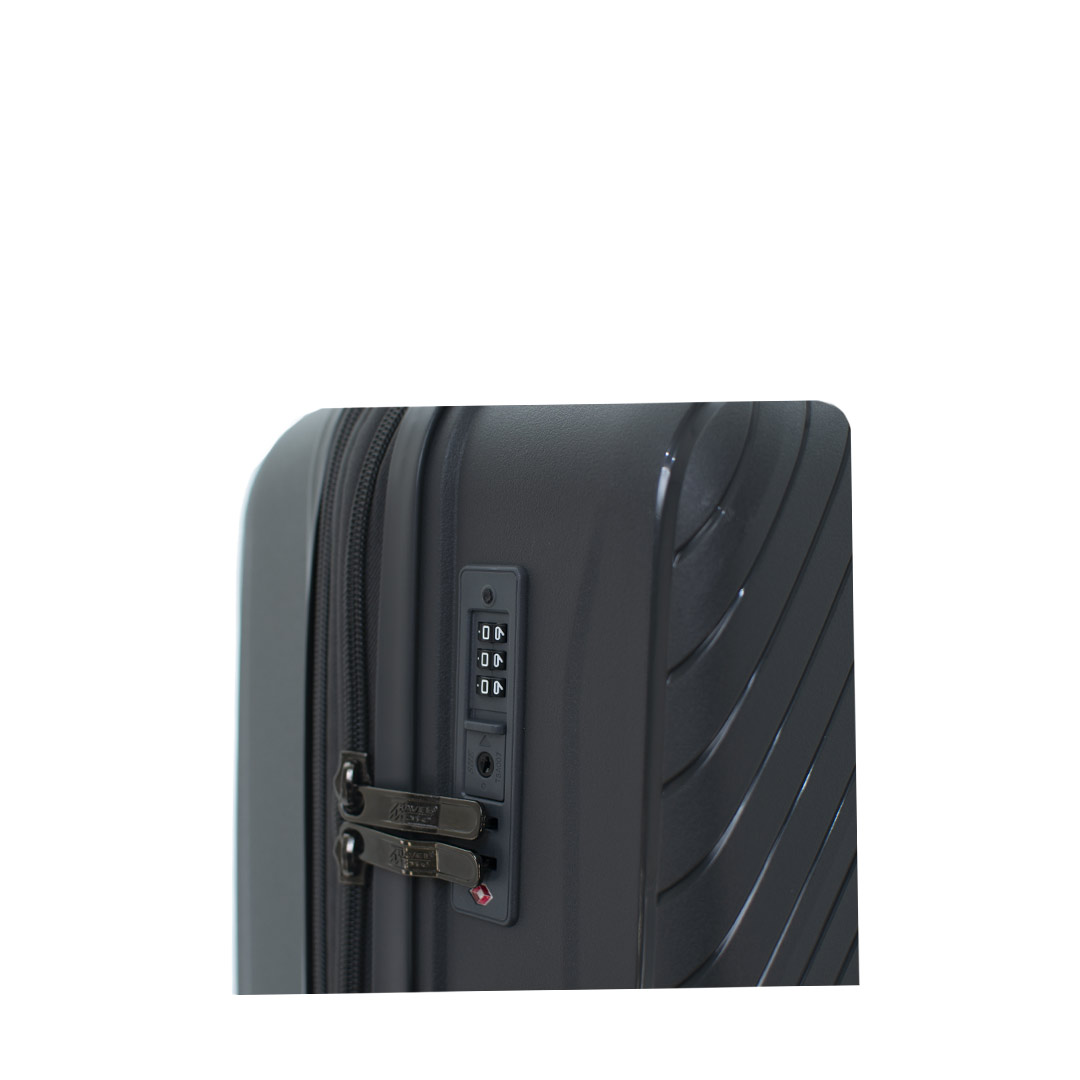 Close-up of a gray hardshell suitcase featuring a combination lock and textured surface for added protection.