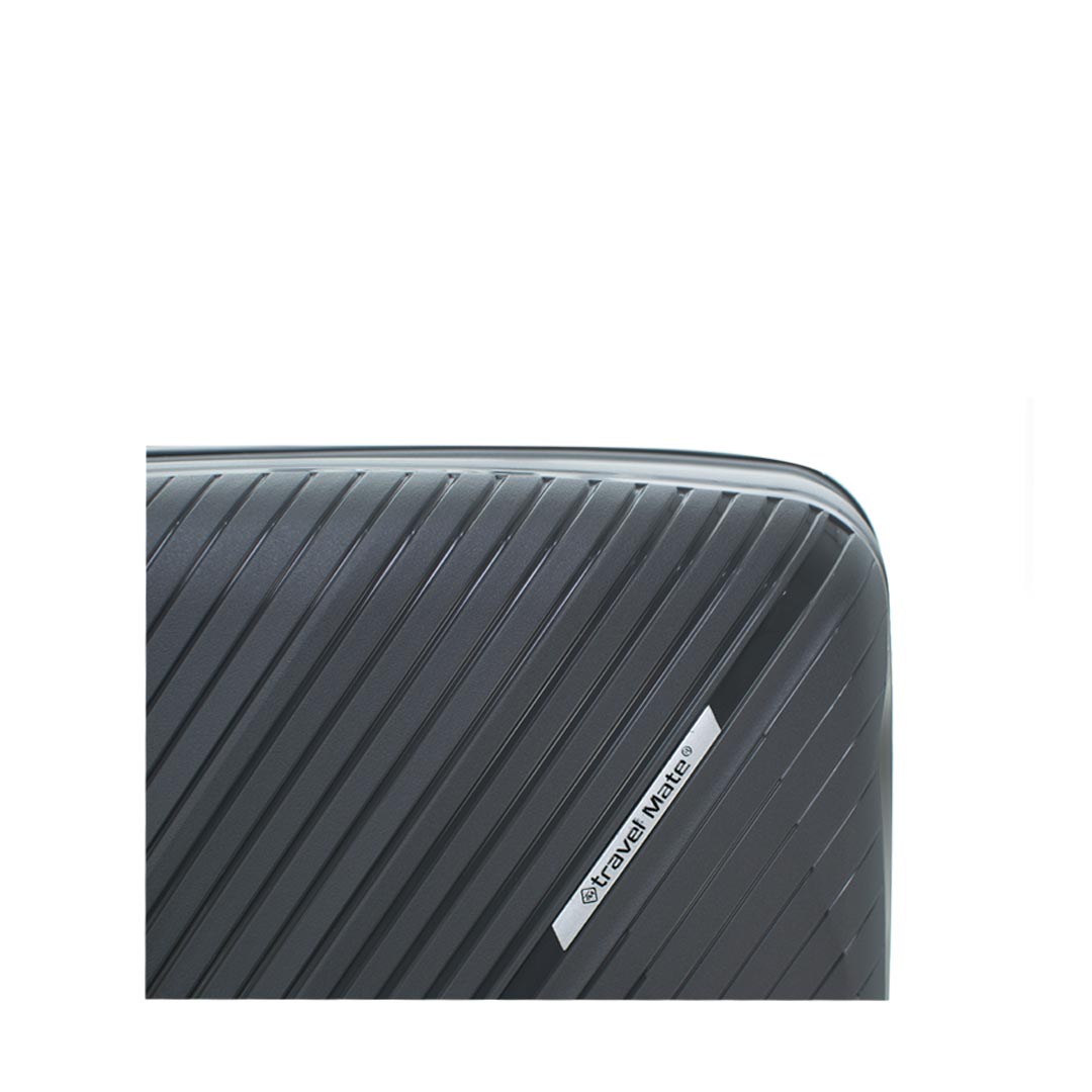 Close-up of a black hardshell suitcase with a textured surface and a logo labeled "travel mate."